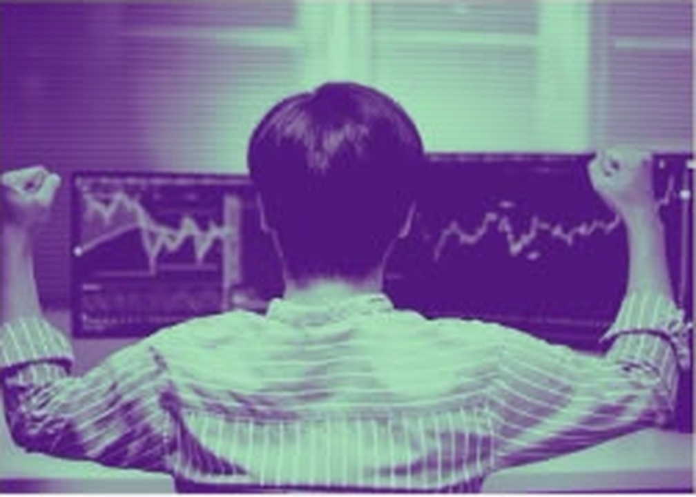 An experienced trader at a multi-monitor desk ready to move into crypto